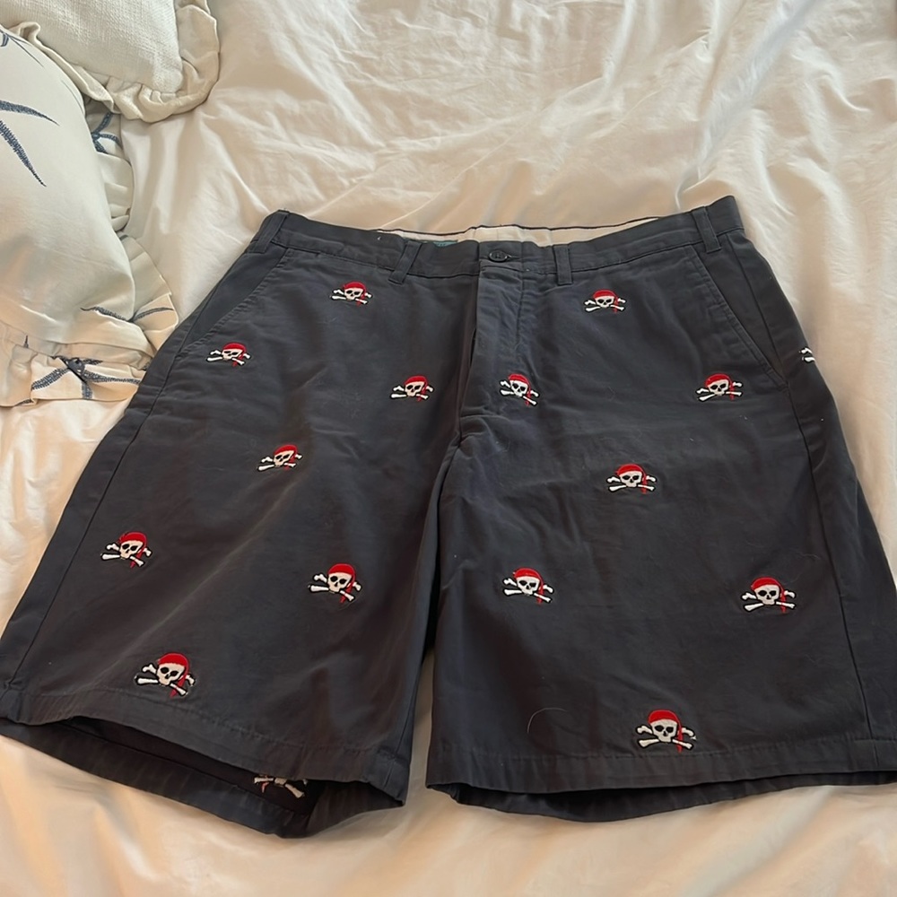Castaway Nantucket navy blue shorts with skull and cross bones with red cap